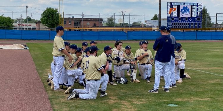 Shady Spring head coach Jordan Meadows huddles with his team after an 11-5 win over Princeton at Hunnicutt Field on Saturday.