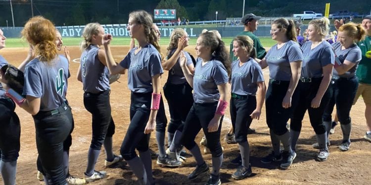 Wyoming East players congratulate each other after a win against James Monroe earlier this season.