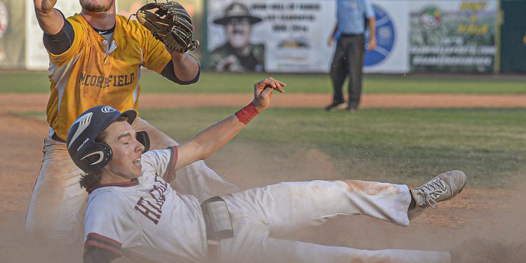 Moorfield’s Hayden Baldwin shows the unpire the ball after tagging out Mna’s Jace Adkins as the first out of the final inning during Class A state tournament action in Charleston. (F. Brian Ferguson/Lootpress)
