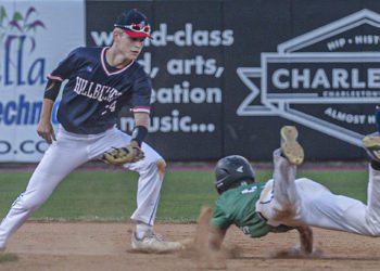Man shortstop Caleb Blevins waits to put the tag on Charleston Catholic’s Evan Sayre during a failed steal attempt during Friday’s Class A State Tournament game in Charleston. (F. Brian Ferguson/Lootpress)
