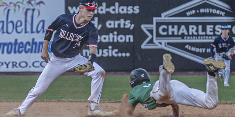 Man shortstop Caleb Blevins waits to put the tag on Charleston Catholic’s Evan Sayre during a failed steal attempt during Friday’s Class A State Tournament game in Charleston. (F. Brian Ferguson/Lootpress)