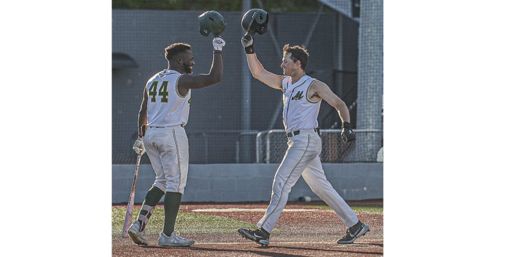 WV Miners Malik Williams, (left) taps helmets with Patrick Mills after Mills hit a towering home run during Tuesday evening action against Champion City. (F. Brian Ferguson/Lootpress)