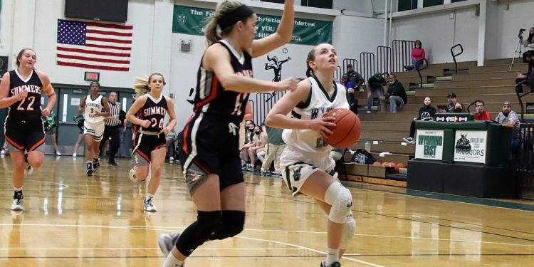 Wyoming East's Abby Russell (right) drives to the basket against Summers County's Taylor Isaac during the Class AA Region 3, Section 1 championship on April 16 in New Richmond. (Photo: Jim Cook)