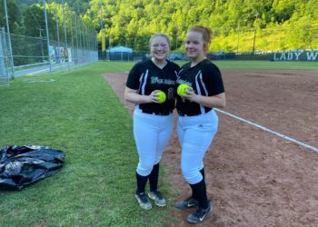 Wyoming East's Andrea Laxton (left) and Megan Cook (right) pose with their home run balls after beating Independence 5-2 Tuesday night in New Richmond.