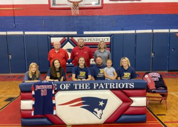 Emily Suddreth (first row, center) is surrounded by coaches and family as she signs to continue her career at Bluefield State. Pictured (from left to right) in the bottom row is Abigail Suddreth, Daphne Suddreth, Emily Suddreth, Keith Suddreth, Kynlee Suddreth and Kennedy James. Pictured in the back row (from left to right) is Independence assistant coach David "Scotty" Cuthbert, Head Coach Mark Cuthbert, and assistant coach Kayla Hart. (Submitted Photo)
