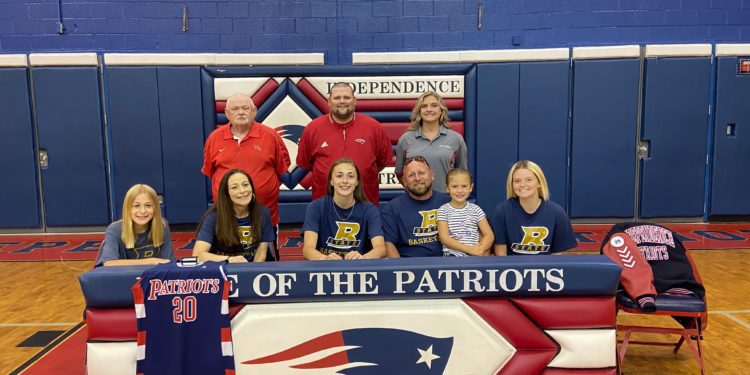 Emily Suddreth (first row, center) is surrounded by coaches and family as she signs to continue her career at Bluefield State. Pictured (from left to right) in the bottom row is Abigail Suddreth, Daphne Suddreth, Emily Suddreth, Keith Suddreth, Kynlee Suddreth and Kennedy James. Pictured in the back row (from left to right) is Independence assistant coach David "Scotty" Cuthbert, Head Coach Mark Cuthbert, and assistant coach Kayla Hart. (Submitted Photo)