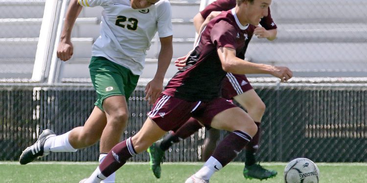 (Brad Davis/For LootPress) Woodrow Wilson's Carson Eckley charges past Brooke's Kendrick Fish before scoring on the play Aug. 28 at the YMCA Paul Cline Memorial Sports Complex.