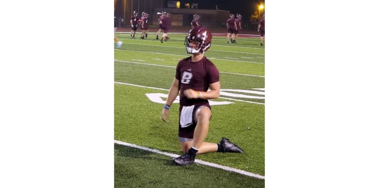 Beckley quarterback Maddex McMillen stretches out during midnight practice at Van Meter Stadium on Monday morning in Beckley. (Rusty Udy)
