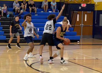 Greenbrier West's Chase McClung (right) looks to pass out of a trap during a game against Bluefield on July 19 in Shady Spring.