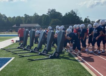 The Independence linemen take turns pushing the sled during a hot practice on Aug. 11.