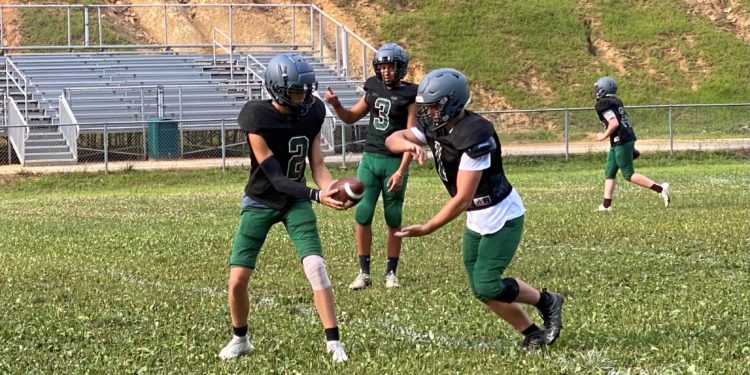 Wyoming East quarterback Jackson Danielson practices a handoff in New Richmond on Tuesday evening.