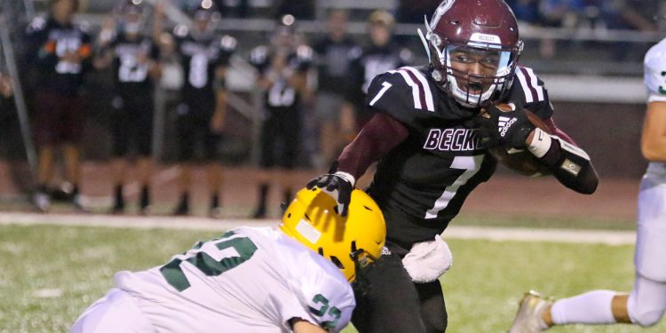 (Brad Davis/For LootPress) Woodrow Wilson's Tylai Kimble tries avoid a tackle by Greenbrier East's Jake Pate last year in Beckley.