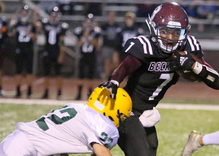 (Brad Davis/For LootPress) Woodrow Wilson's Tylai Kimble tries avoid a tackle by Greenbrier East's Jake Pate last year in Beckley.