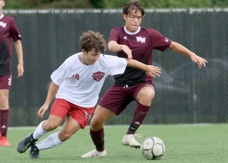 (Brad Davis/For LootPress) Woodrow Wilson's Jackson Quattrone battles for possession with Bridgeport's Brock Amos Saturday afternoon at the YMCA Paul Cline Memorial Sports Complex.
