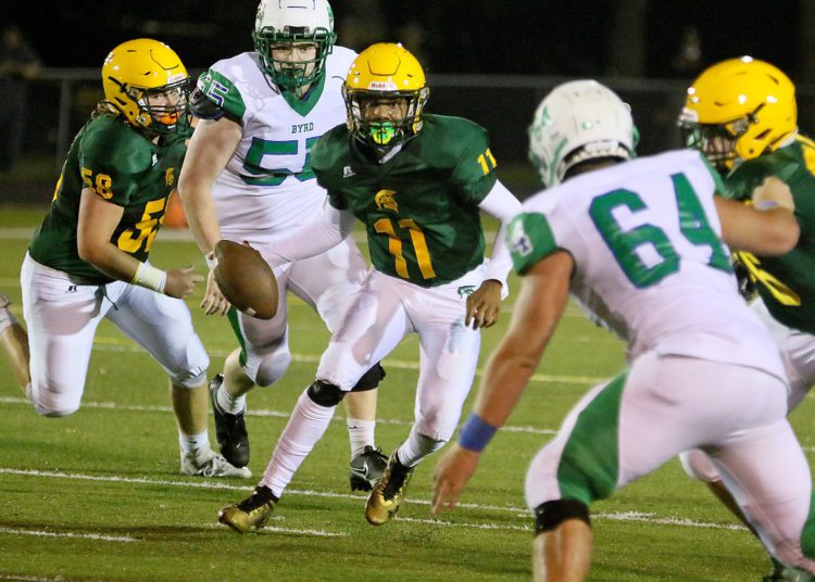 (Brad Davis/For LootPress) Greenbrier East quarterback Monquelle Davis is forced from the pocket as he looks for an open receiver against Robert C. Byrd Friday night in Fairlea