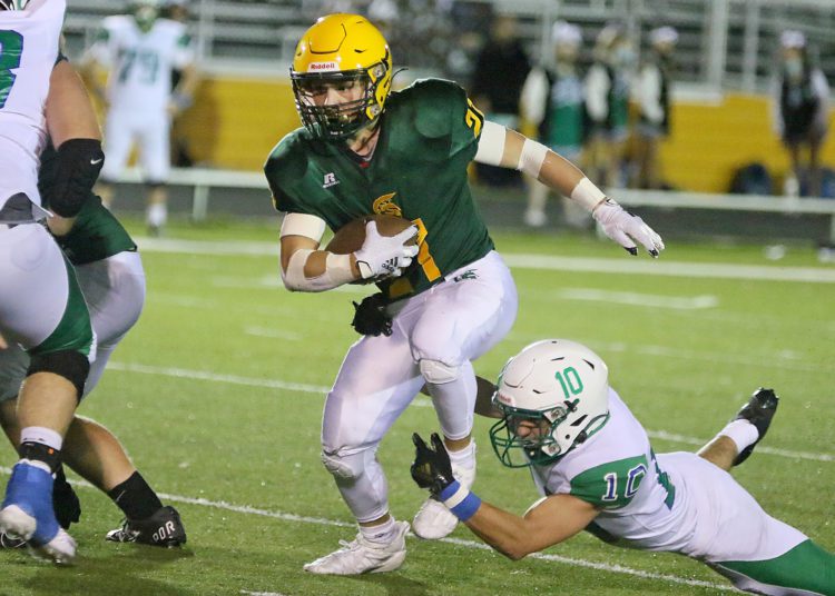 (Brad Davis/For LootPress) File Photo - Greenbrier East's Ian Cline breaks a tackle attempt from Robert C. Byrd's Evan Warne as he carries the ball Sept. 10 in Fairlea