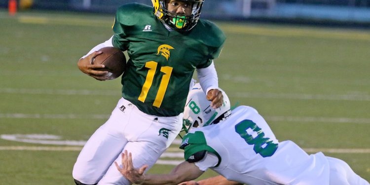 (Brad Davis/For LootPress) Greenbrier East quarterback Monquelle Davis gets past Robert C. Byrd defender Jaidan Willis Sept. 10 in Fairlea.