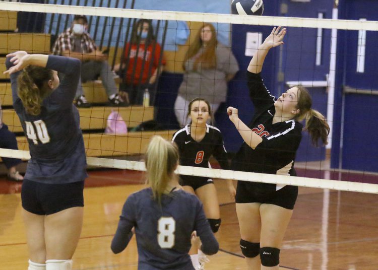 (Brad Davis/For LootPress) Liberty's Jovie Mains attacks as Nicholas County's Kelsi Foster tries to block during a tri-match hosted by Independence Wednesday night in Coal City.