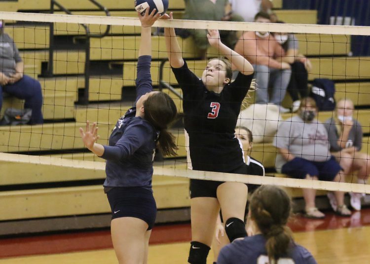 (Brad Davis/For LootPress) Liberty's Lacie Turner and Nicholas County's Jenna Grose meet at the net during a tri-match hosted by Independence Wednesday night in Coal City.