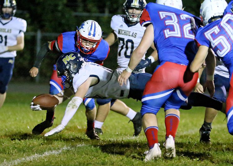 (Brad Davis/For LootPress) Nicholas County's Kaleb Clark dives across the goal line for a touchdown against Midland Trail Friday night in Hico.