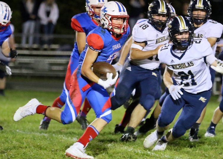 (Brad Davis/For LootPress) Midland Trail's Cody Harrell carries the ball against Nicholas County Friday night in Hico.