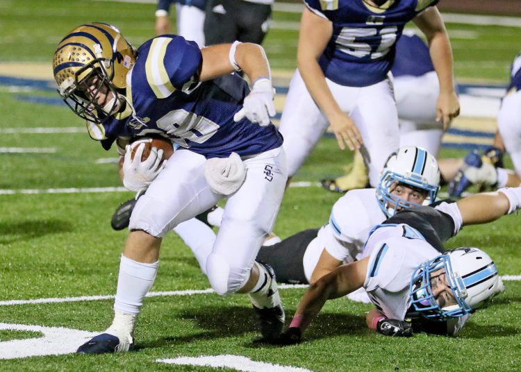 (Brad Davis/For LootPress) Shady Spring running back Caleb Whittaker breaks a tackle attempt by Mingo Central's Kyle Campbell Friday night at Shady.