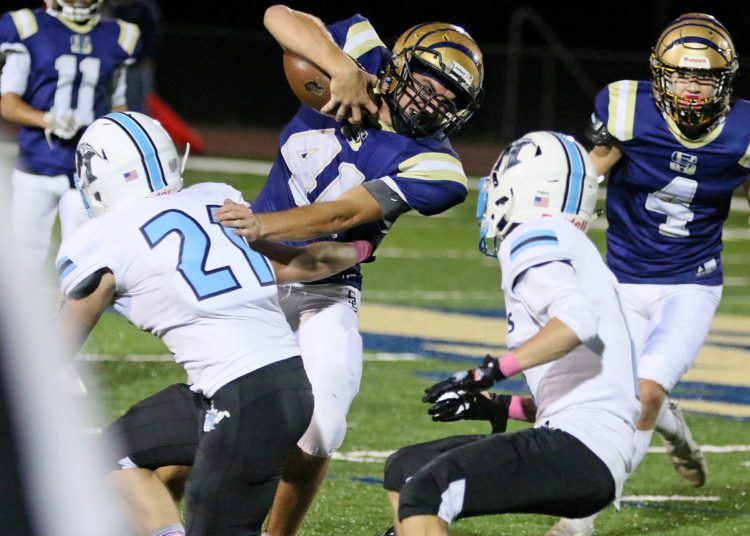 (Brad Davis/For LootPress) Shady Spring running back Bryson Pinardo breaks a tackle attempt by Mingo Central's James Lester II Friday night at Shady.