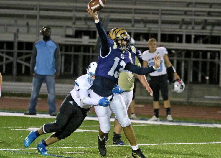 (Brad Davis/For LootPress) Shady Spring quarterback Cameron Manns is hit as he throws against Mingo Central Friday night at Shady.