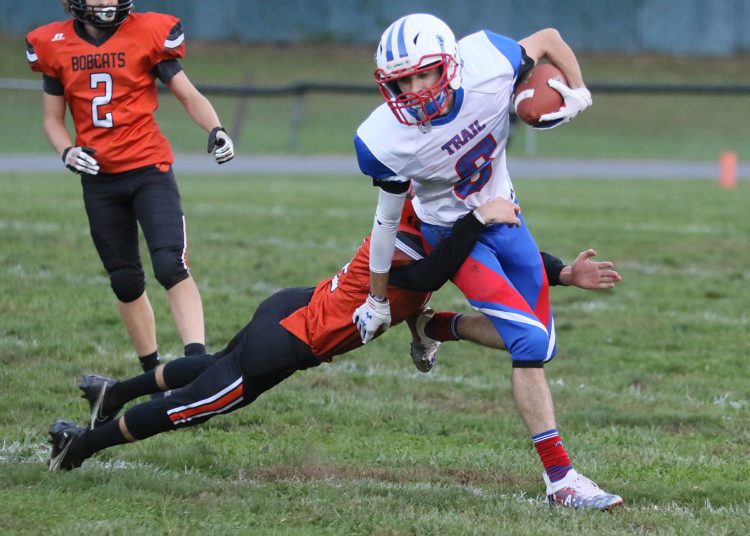 (Brad Davis/For LootPress) Midland Trail's Matt Light carries the ball as Summers County defender Benjamin Lane dives to tackle him last season in Hinton.