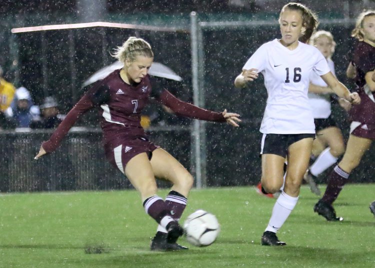 (Brad Davis/For LootPress) Woodrow Wilson's Sophie Hall sends a ball downfield as Oak Hill defender Kerrisyn Feazell converges on her Thursday night in Beckley.