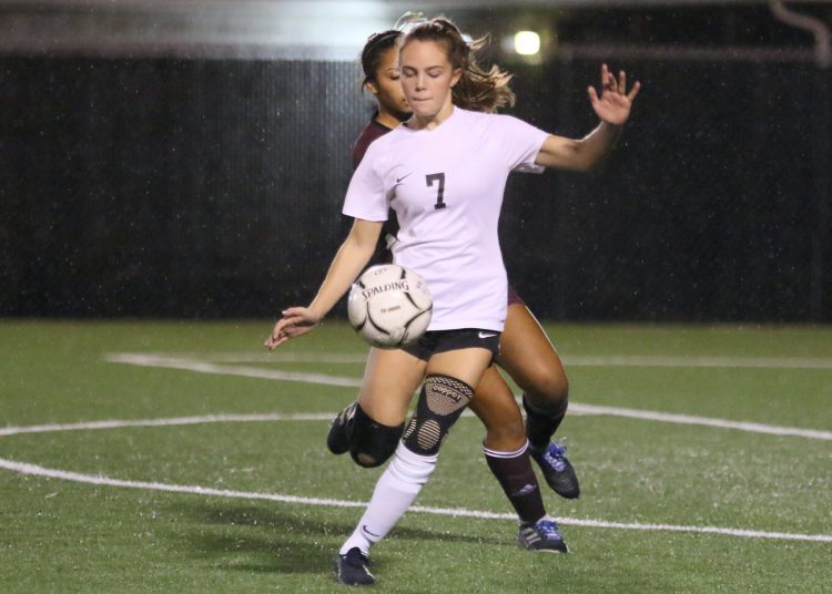 (Brad Davis/For LootPress) Oak Hill's Samantha Dean battles for possession with Woodrow Wilson's Alisae Berg Thursday night in Beckley.