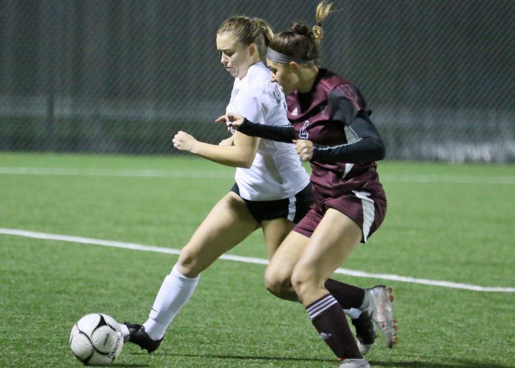 (Brad Davis/For LootPress) Oak Hill's Shyanne Friebel battles for possession with Woodrow Wilson's Mia Houck Thursday night in Beckley.