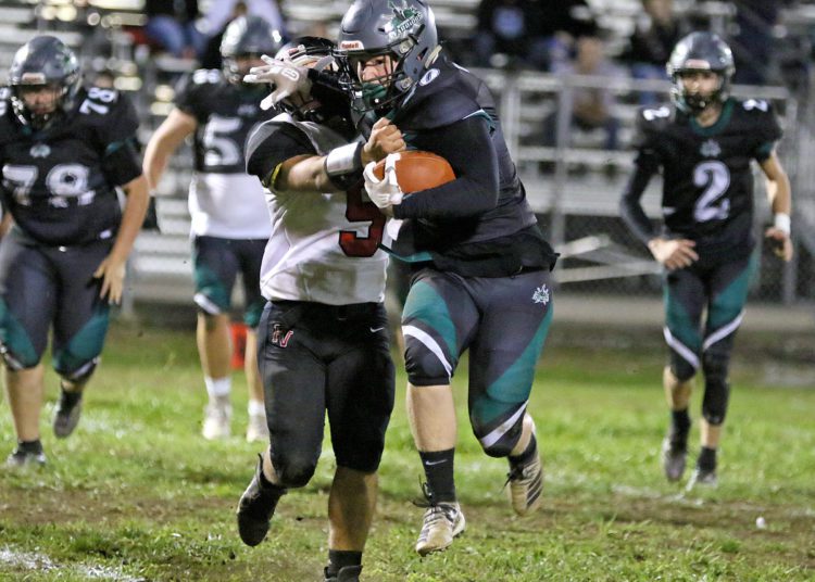 (Brad Davis/For LootPress) Wyoming East's Gabriel Riling stiff-arms PikeView defender Austin Shrewsbury as he carries the ball Friday night in New Richmond.