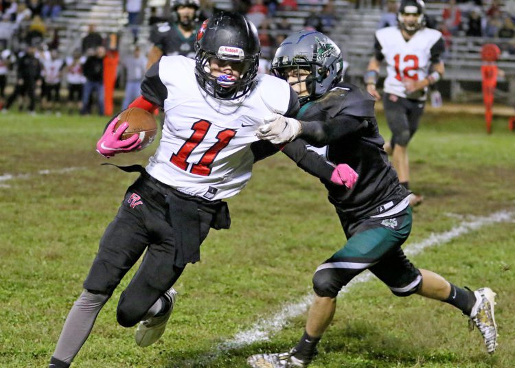 (Brad Davis/For LootPress) PikeView's Braydon Dalton carries the ball as Wyoming East's Dustin Belcher tires to make the tackle Friday night in New Richmond.