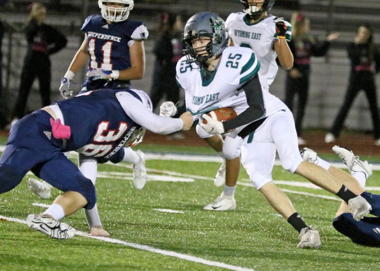 (Brad Davis/For LootPress) Wyoming East's #25 is tackled by Independence defender Jordan Harvey after making a catch for a first down Friday night in Coal City.
