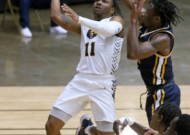 (Brad Davis/For LootPress) WVU Tech's Juvante' Hayes drives to the basket as Alderson Broaddus' John Grayson defends Friday night at the Beckley-Raleigh County Convention Center.