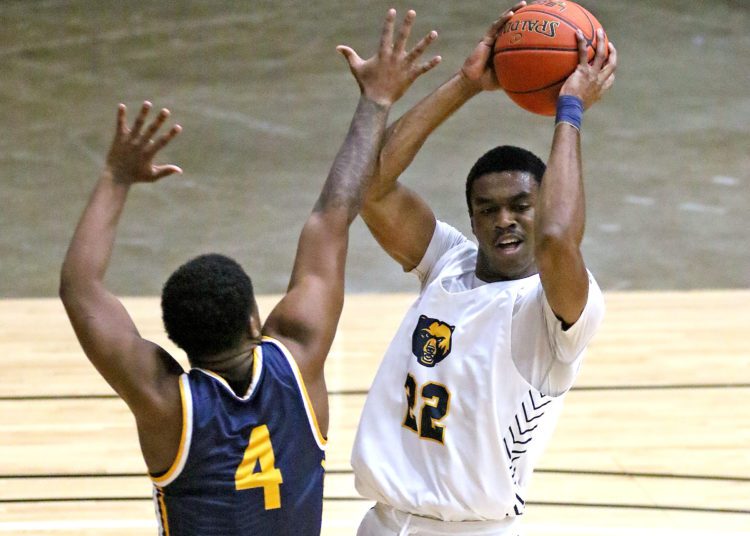 (Brad Davis/For LootPress) WVU Tech's Thomas Hailey looks for an open teammate as he's defended by Alderson Broaddus' Coryon Rice Friday night at the Beckley-Raleigh County Convention Center.