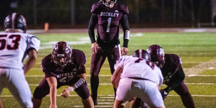 Beckley QB Maddex McMillen surveys the defense before a snap during a game against Oak Hill on Oct. 30 in Beckley. (Heather Belcher/Lootpress).