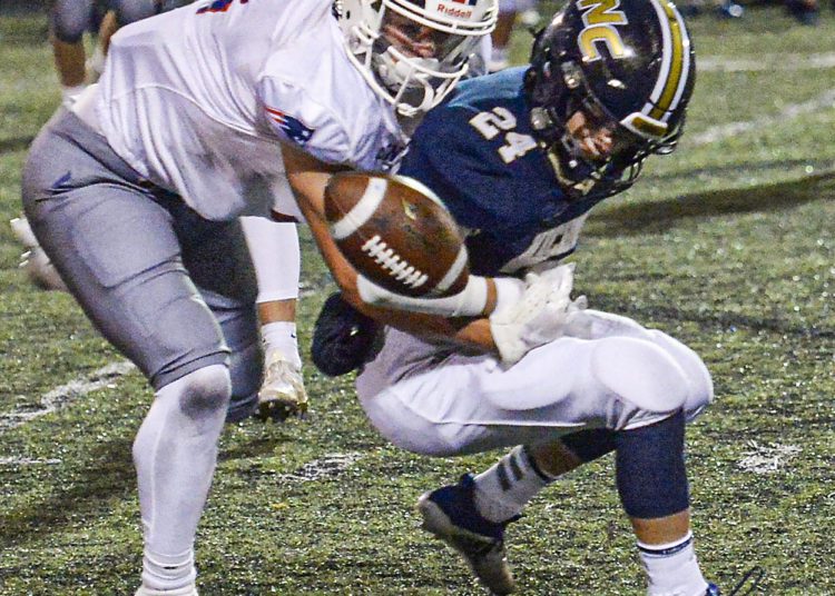 Independence’s Trey Bowers, left, strips the ball from Nicholas County’s Grayson Kesterson suring Friday action in Summersville. (F. Brian Ferguson/Lootpress).