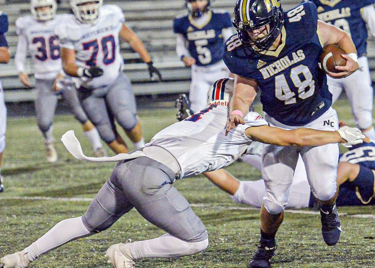Nicholas County’s JP Girod picks up yards against Independence during Friday action in Summersville. (F. Brian Ferguson/Lootpress).