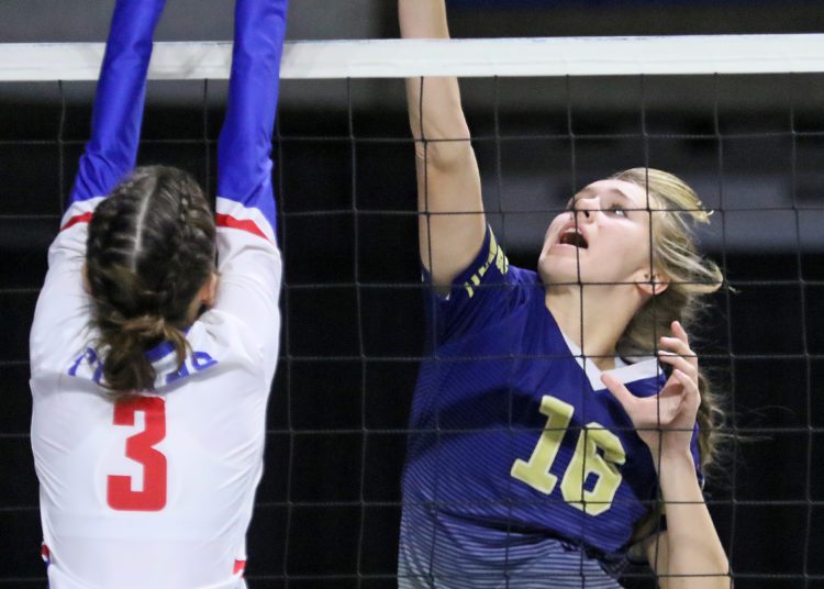 (Brad Davis/For LootPress) Greenbrier West's Kadie O'dell attacks as Gilmer's Harlee McHenry defends during first round action at the State High School Volleyball Tournament Friday morning at the Charleston Civic Center.