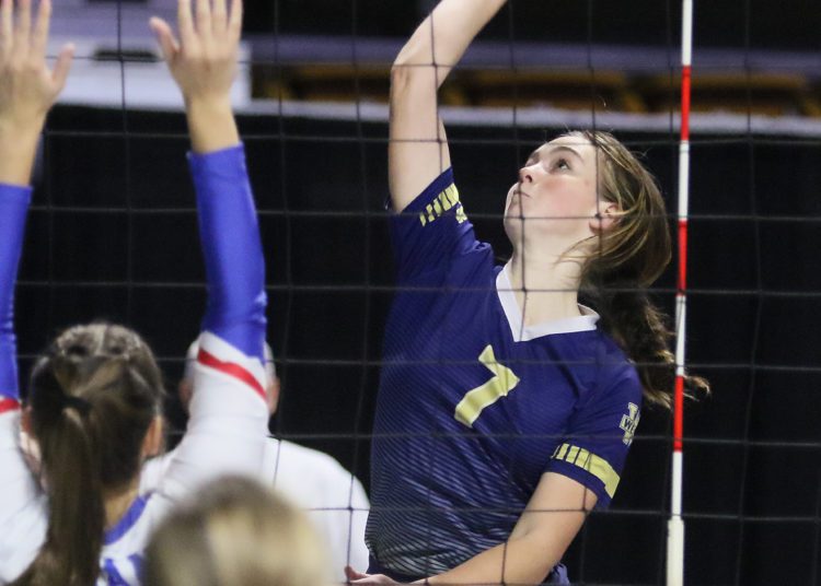 (Brad Davis/For LootPress) Greenbrier West's Loren Hanna attacks as Gilmer's Bayley Frashure defends during first round action at the State High School Volleyball Tournament Friday morning at the Charleston Civic Center.