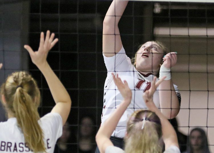 (Brad Davis/For LootPress) Woodrow Wilson's Saira Diehl attacks as George Washington's Delaney Brasselle, left, and Ella Hall defend during first round action at the State High School Volleyball Tournament Friday morning at the Charleston Civic Center.
