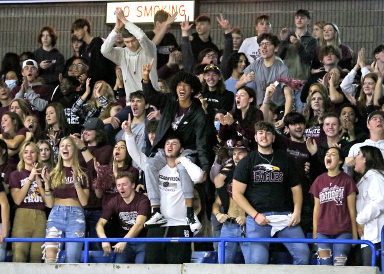 (Brad Davis/For LootPress) Woodrow Wilson students pull for their classmates on the court during the Flying Eagles' first round matchup with George Washington at the State High School Volleyball Tournament Friday morning at the Charleston Civic Center.