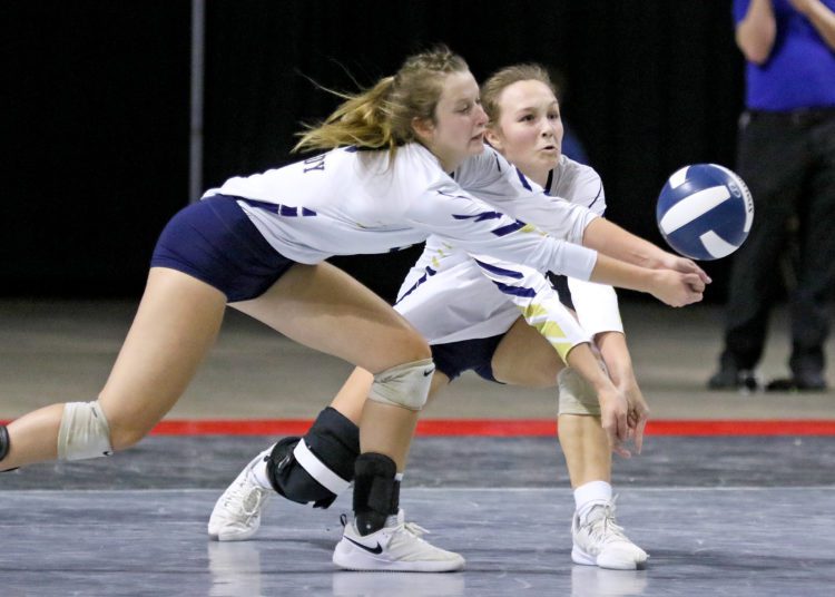 (Brad Davis/For LootPress) Shady Spring's Aly Holdren, left, and Meg Williams both reach for a dig during their Class AA Championship match against Philip Barbour Saturday morning at the Charleston Civic Center.