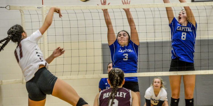 KENNY KEMP | Gazette-Mail
Capital's Tori Barone (3) and Kayla Moffatt (8) try to block the return ball of Woodrow Wilson's Elysia Salon (17).