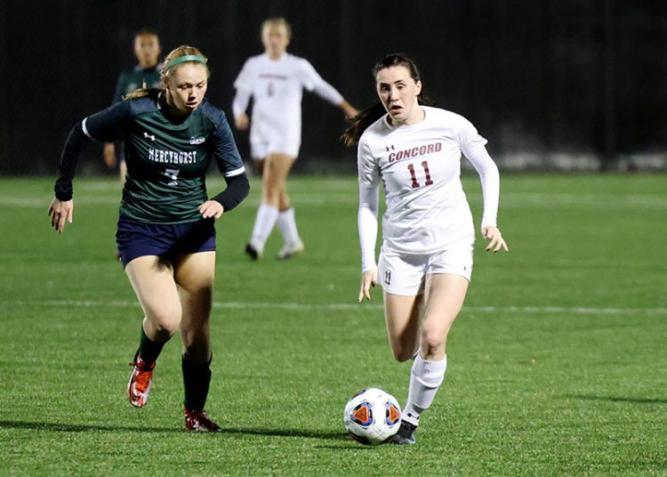 Concord’s Courtney Smith (11) sends a pass to a teammate as Mercyhurst’s Sydney Snyder (7) looks on during the first half of their soccer game in Beckley on Friday, Nov. 18, 2021 (Photo by Chris Jackson)