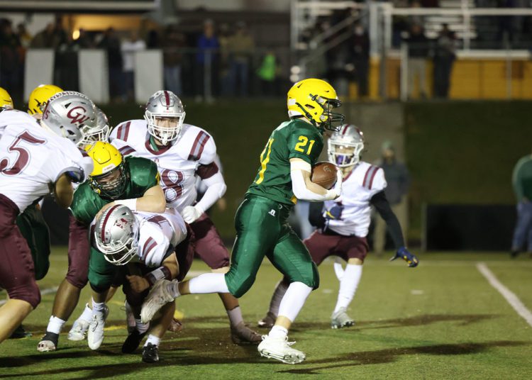 Greenbrier East’s Ian Cline (21) runs through George Washington’s defense during their high school football game in Fairlea on Friday, Nov. 12, 2021 (Photo by Chris Jackson)