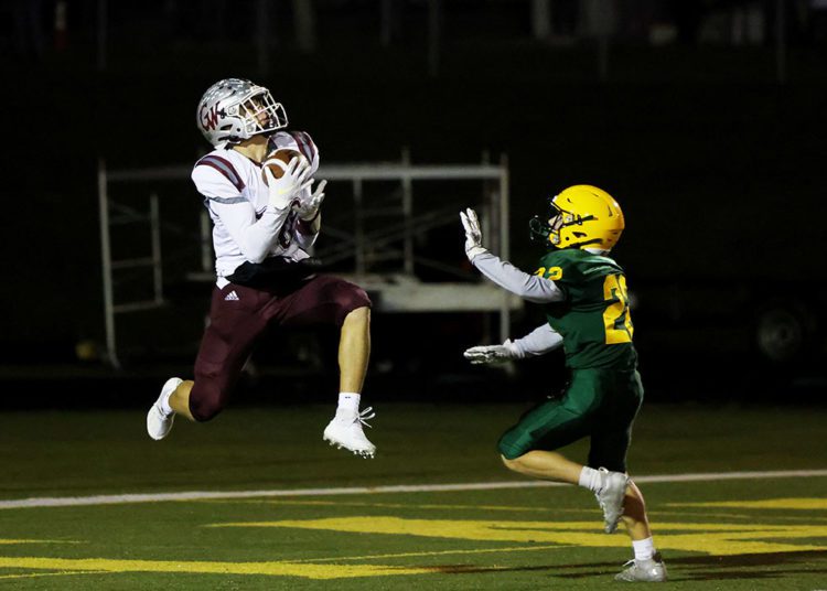 George Washington’s Hayden Hatfield (10) catches a pass for a touchdown as Greenbrier East’s Jake Pate (22) looks on during  their high school football game in Fairlea on Friday, Nov. 12, 2021 (Photo by Chris Jackson)