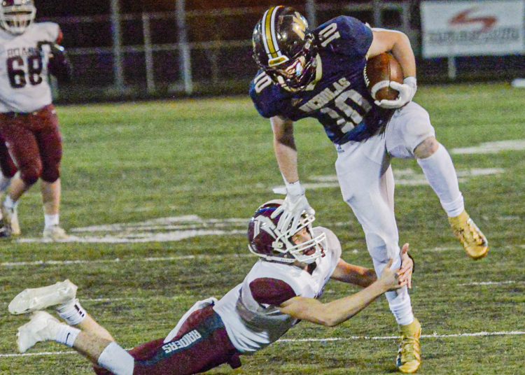 Nicholas County’s Kaleb Clark picks up ground yards against Roane County during Friday action in Summersville. (F. Brian Ferguson/Lootpress)